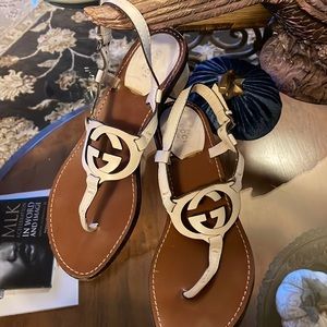 Cream colored block heeled Gucci sandals.